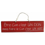 Plaque en bois " Être con c'est un don mais faire le con c'est un art " fond rouge